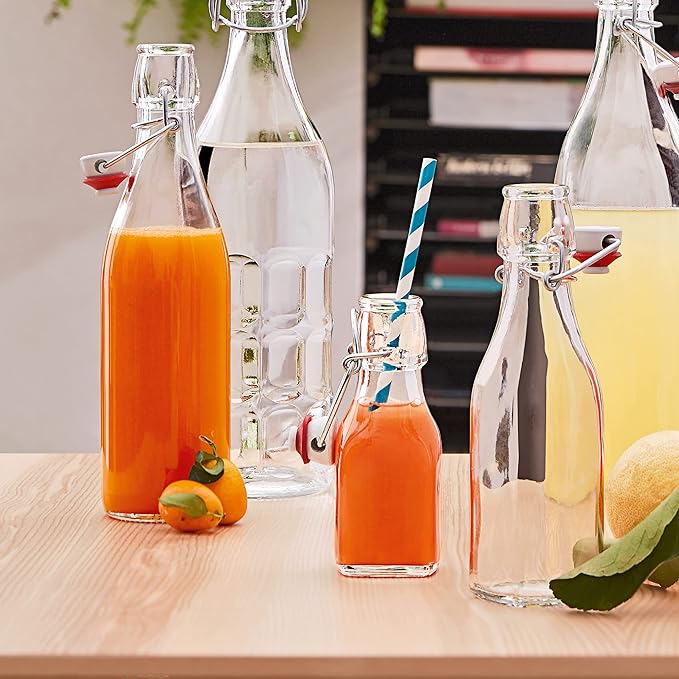 Bormioli Rocco Swing Top Glass Bottle (Set of 4) - Reusable Container with Secure Metal Clasp, Ideal for Homemade Juices, Oil Infusions, Condiments, Mixers - Everyday Drinking Glasses (33.75 Oz.)